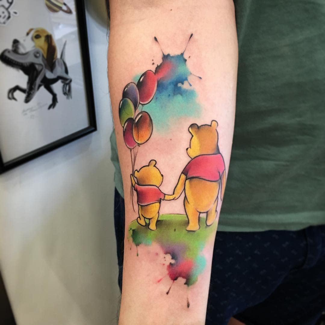 Winnie the Pooh watercolor tattoo with Pooh and child holding balloons, colorful and whimsical